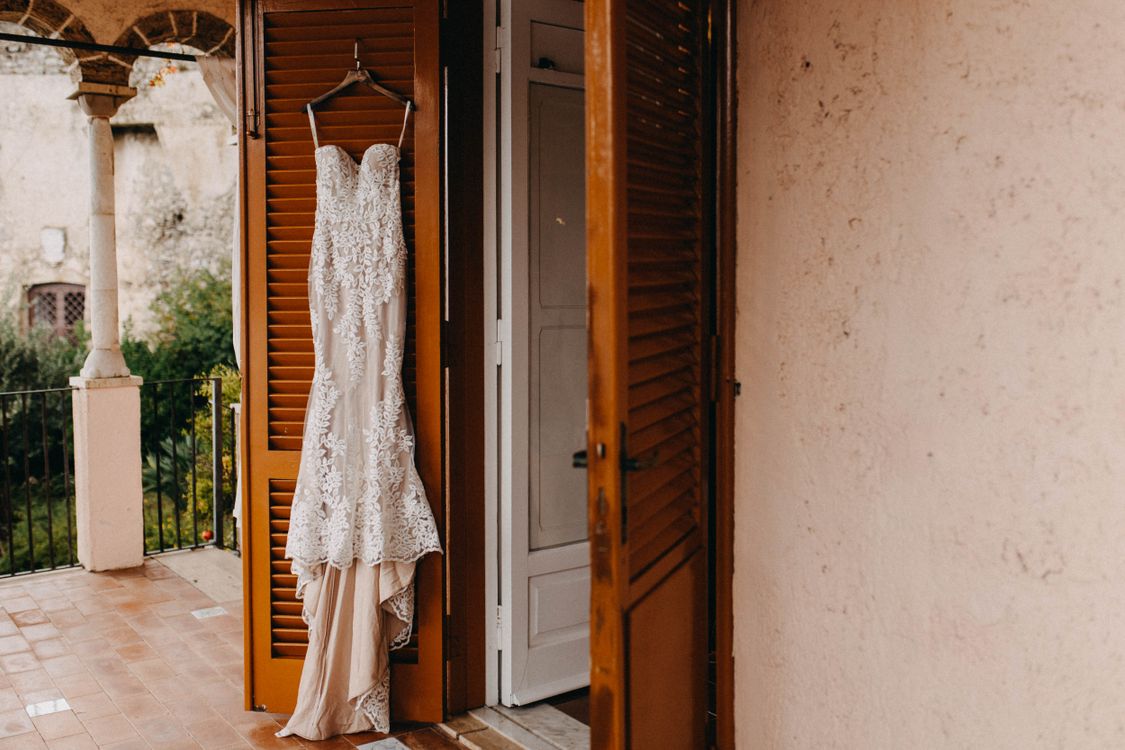 Free White Wedding Dress Hanging On The Door Stock Photo