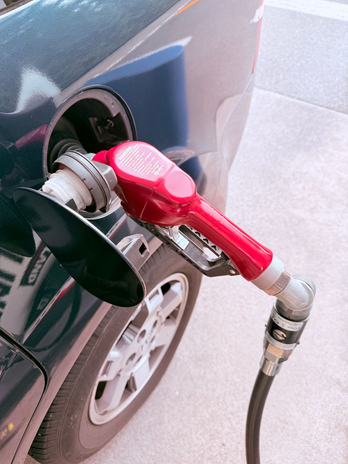 Refuelling a car with diesel at a fuel pump at night