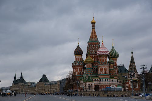 Colorful Concrete Building with Dome Roofs Under Cloudy Sky