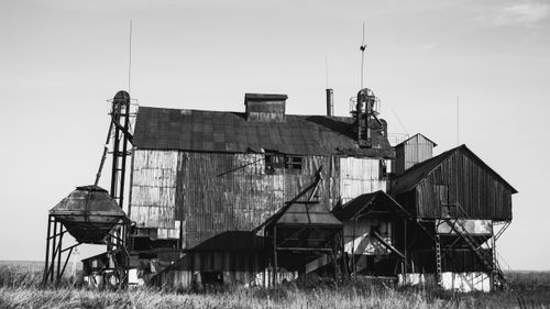 Free A monochrome photo of a derelict industrial building showcasing decay and abandonment. Stock Photo