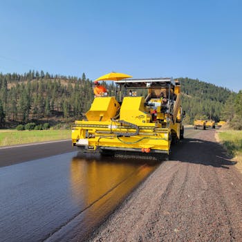 A paving machine laying asphalt on a rural road in Prineville, Oregon.