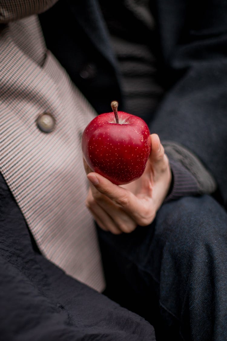 A Hand Holding an Apple 