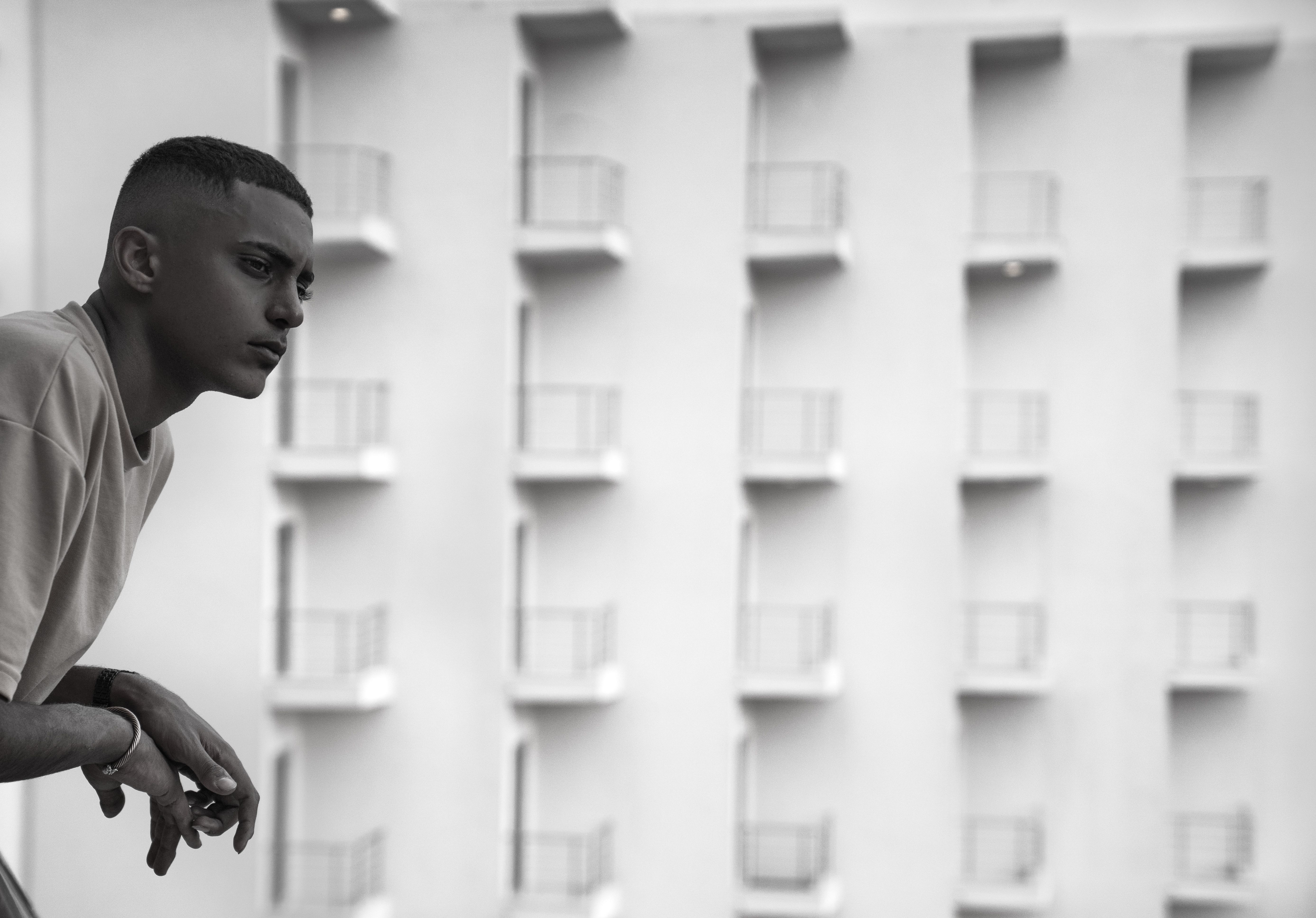 Person looking thoughtfully over a Barcelona balcony - English therapist Barcelona