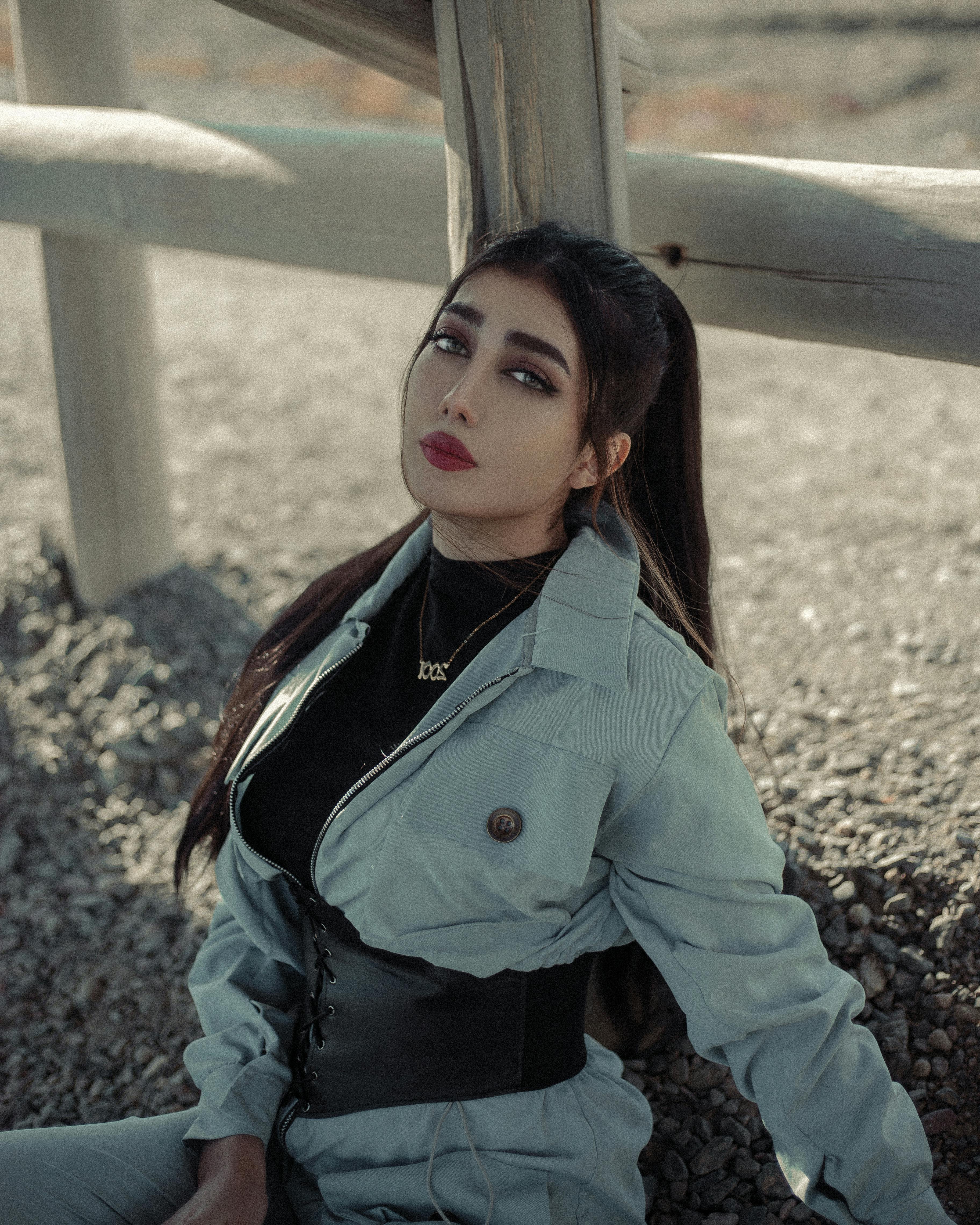 Elegant woman posing outdoors, expressing modern fashion with subtle colors and style.