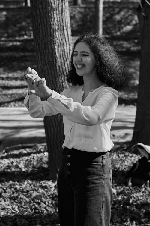 Grayscale Photo of Woman Smiling