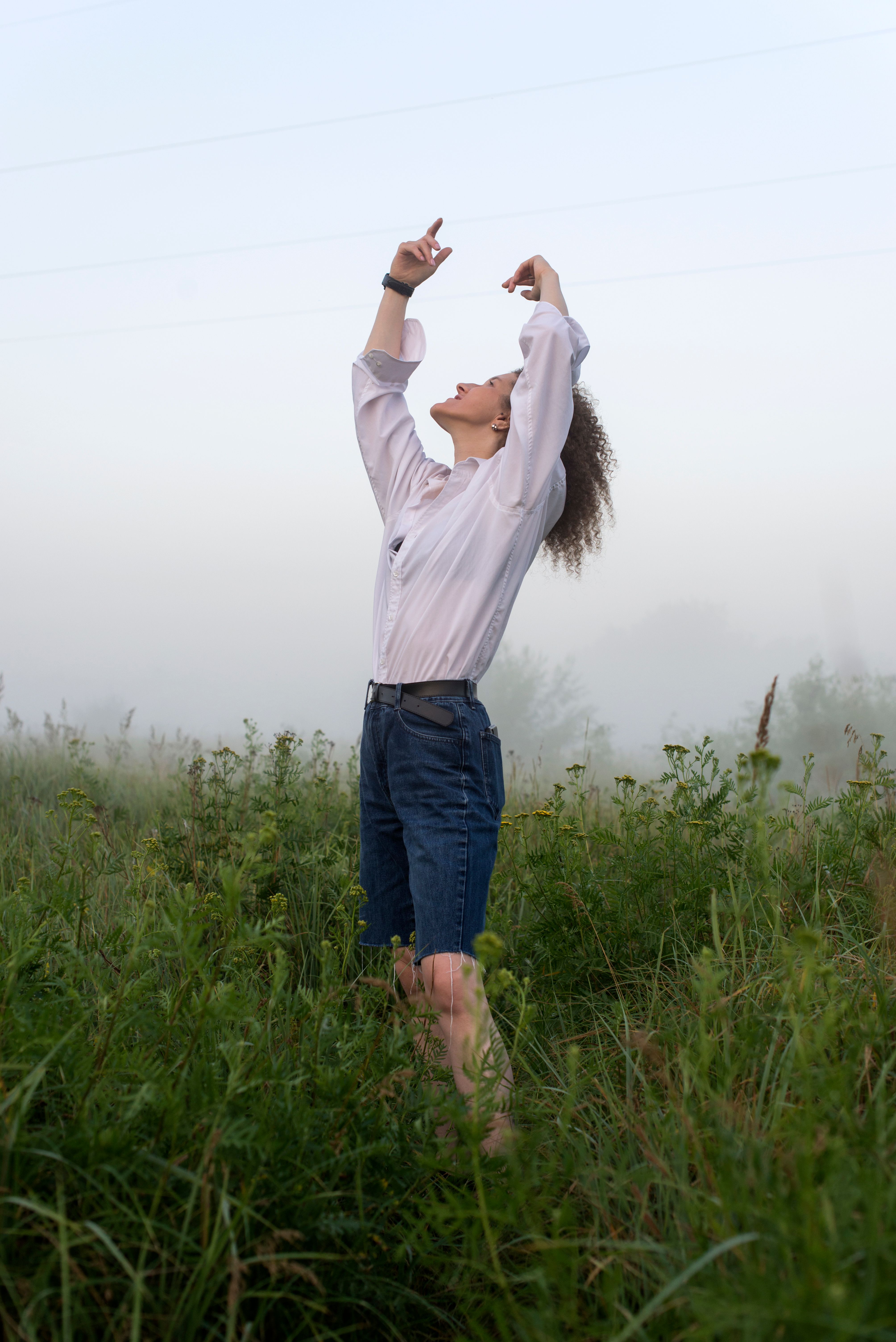 Woman in White Long Sleeves Shirt Standing on Green Grass Field · Free ...