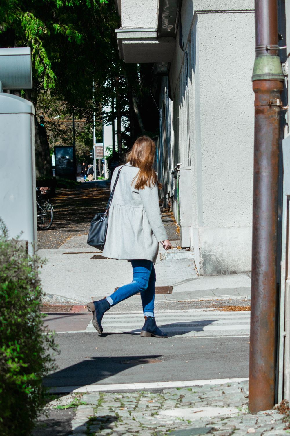 Woman in White Coat and Blue Denim Jeans Walking on Street · Free Stock ...