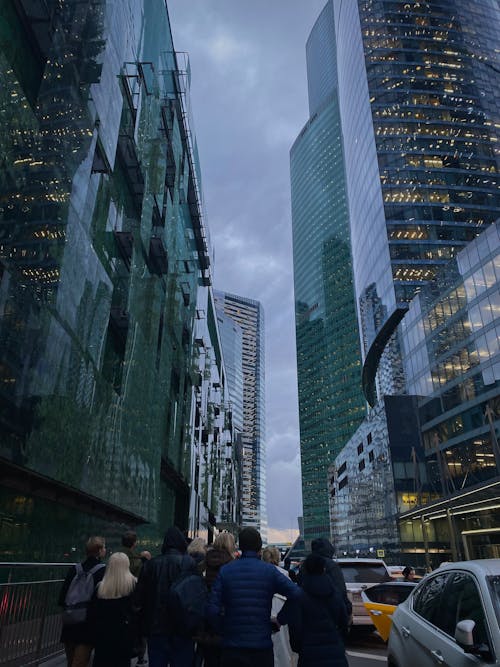 A Low Angle Shot of a Buildings in the City with People Walking on the Street
