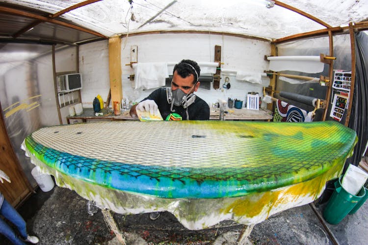 A Man Making A Surfboard