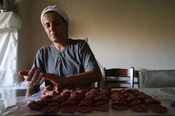 Woman Wearing Black and White Striped Top Preparing Food