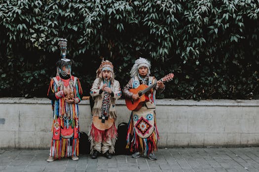 Three musicians in traditional attire performing with guitar and flute outdoors.