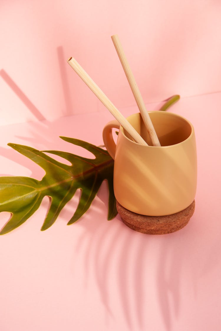 
A Close-Up Shot Of A Cup With Bamboo Straws