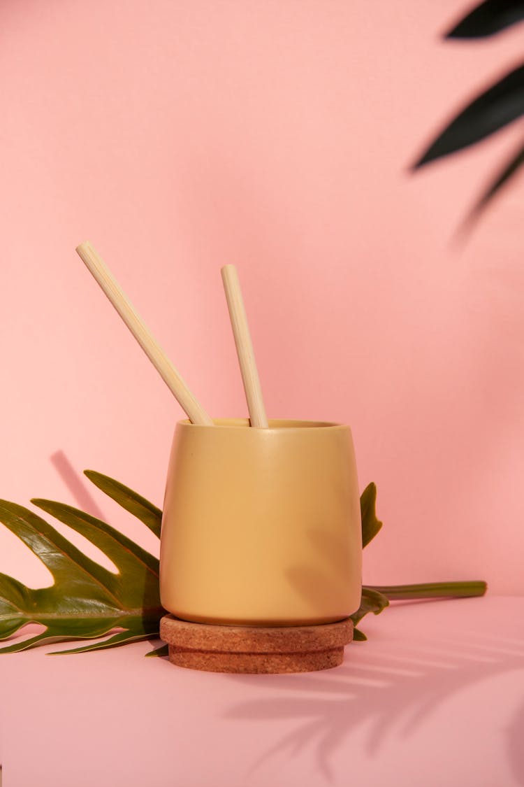 
A Close-Up Shot Of A Cup With Bamboo Straws