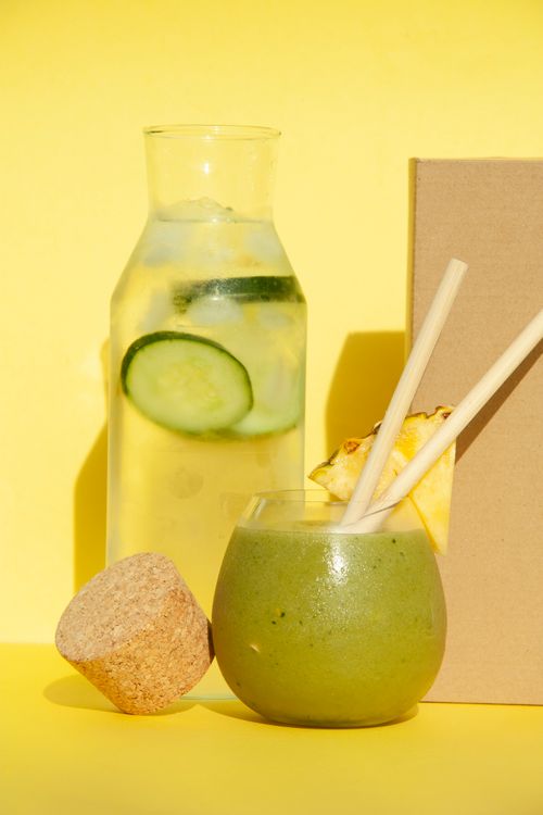 Free A cool, healthy green smoothie and infused water on a bright yellow background. Stock Photo