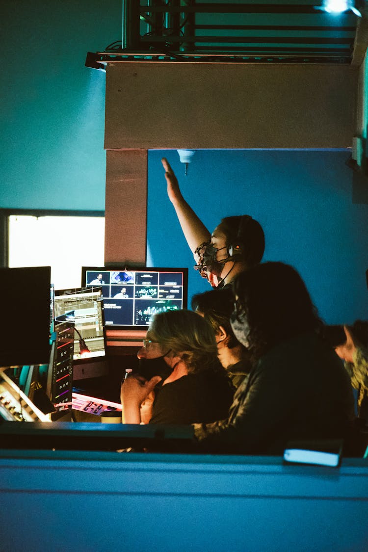 Group Of Men With Face Masks Using Computers