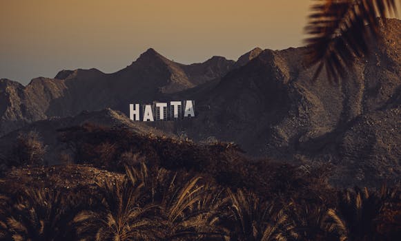 Stunning view of Hatta mountains with signage at sunset, United Arab Emirates.