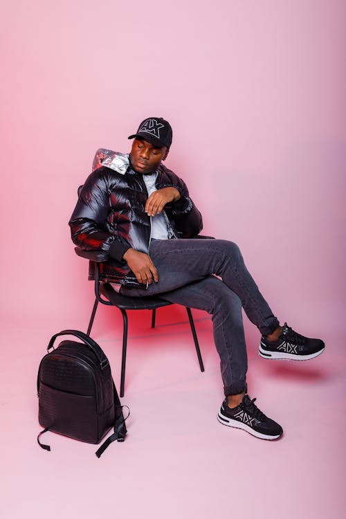 A Man in a Puffer Jacket Sitting on a Chair