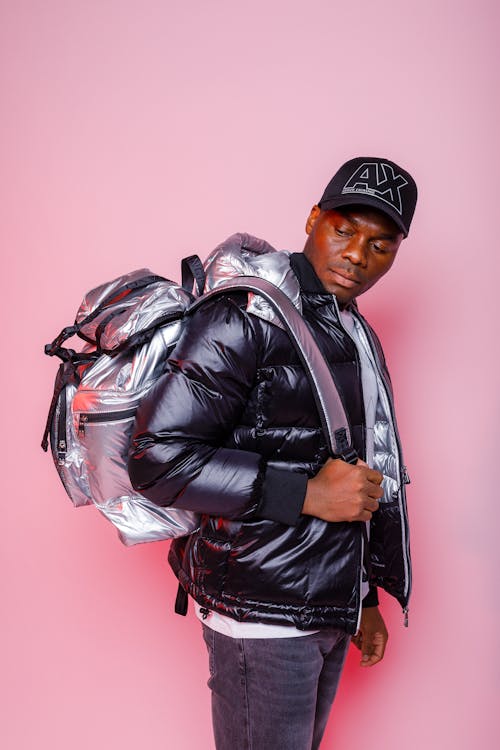 A Man Looking at His Silver Backpack