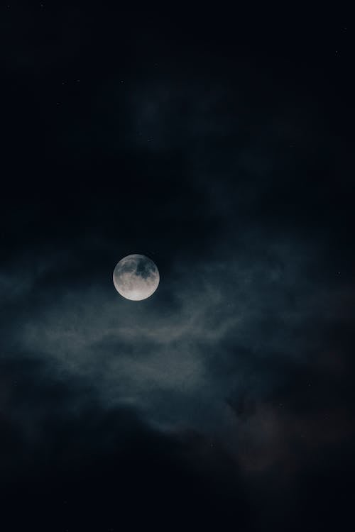 Photograph of Clouds Under a Full Moon