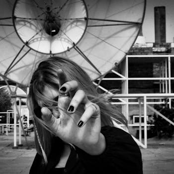 Striking black and white image of a woman gesturing with manicured nails.