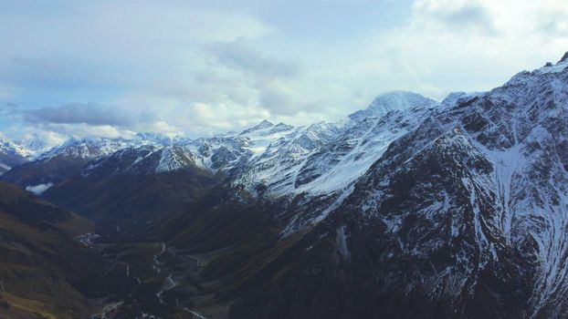 A majestic view of the snow-capped mountains in Terskol, Russia, showcasing winter beauty.