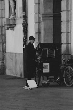 Elderly woman standing by a bicycle rickshaw on a historic street in Graz, Austria.