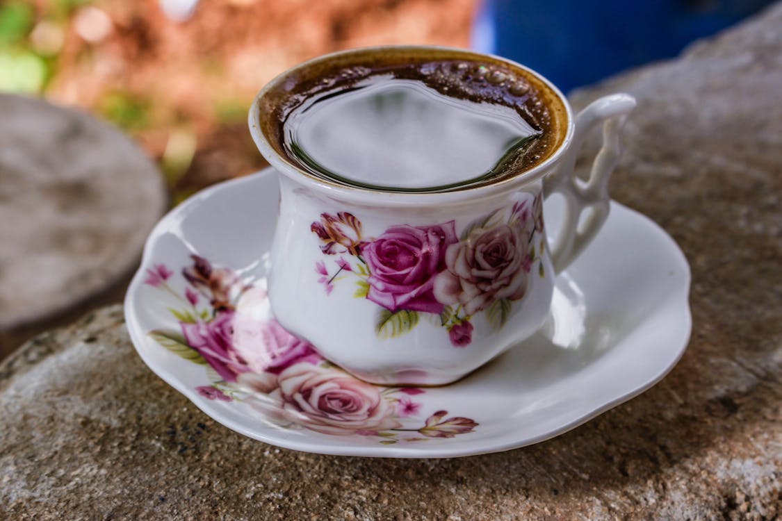 Free White and Pink Ceramic Floral Teacup With Saucer Stock Photo