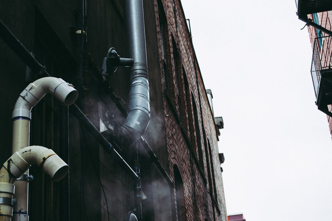 Gray Pipe on Building Wall
