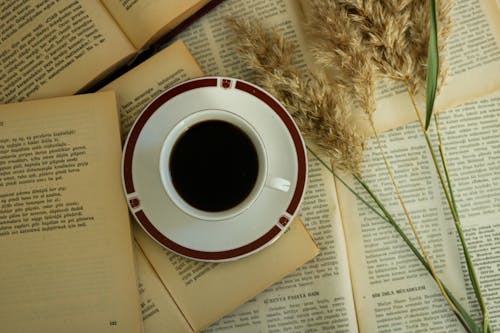 
A Cup of Coffee over Open Books