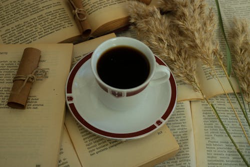 Cup of Coffee on Open Books 