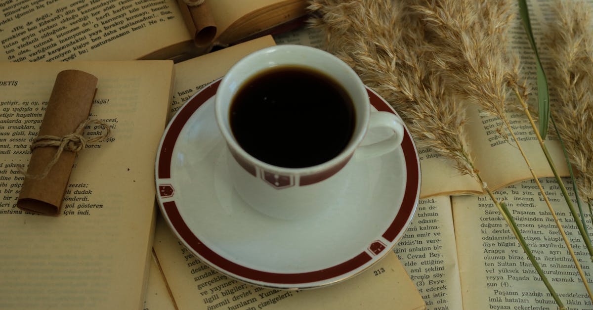 Cup of Coffee on Open Books · Free Stock Photo