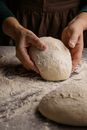 Person Holding White Dough on Gray Sand