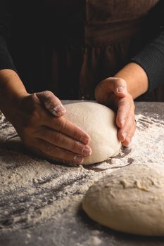 A Person Shaping a Lump of Dough 