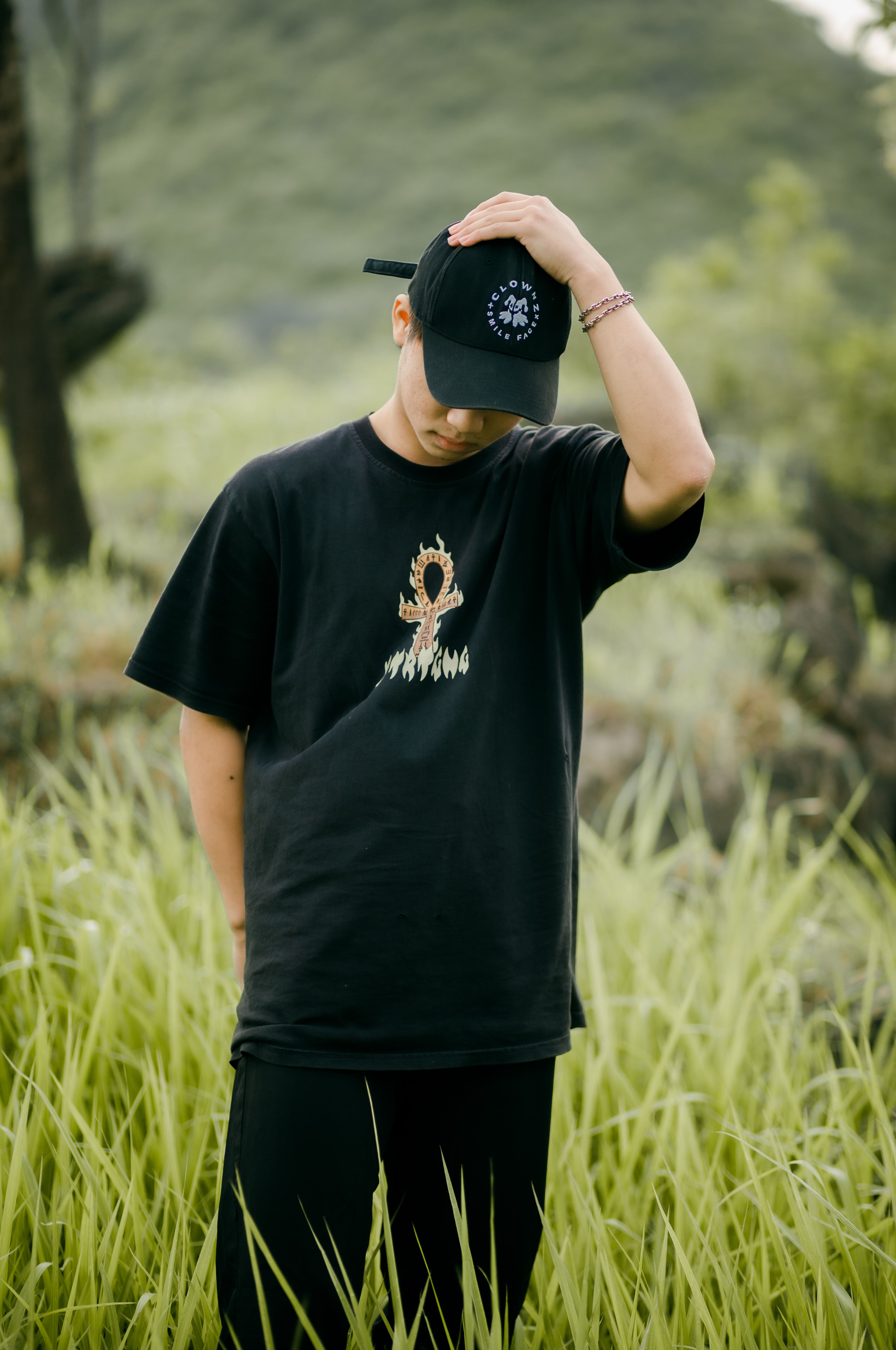 Man in All Black Outfit Standing on Green Grass Field · Free Stock Photo