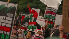 People Holding Red White and Green Banner