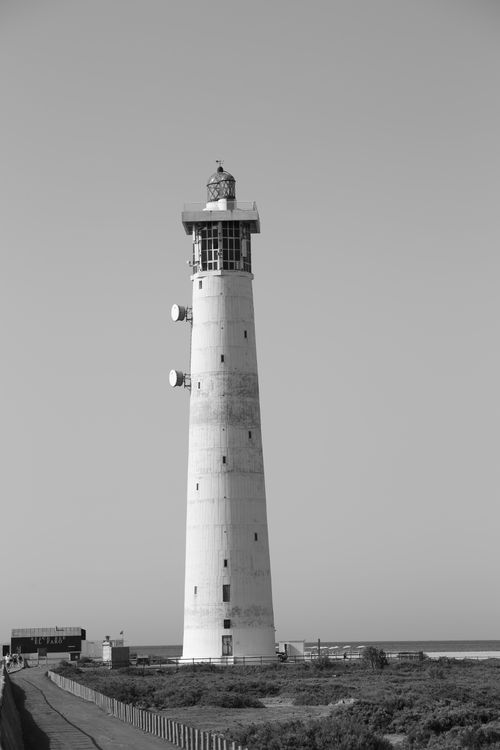 Free Black and white photo of a lighthouse in Canary Islands, Spain, on a clear day. Stock Photo