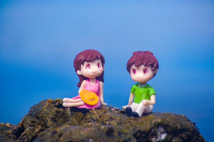 Toy Figures On Mossy Rock