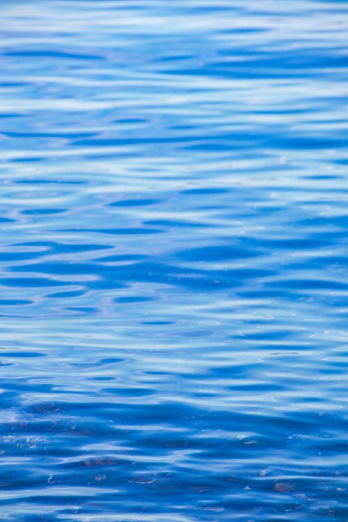 Free A serene view of bright blue ocean water with gentle ripples creating a calming effect. Stock Photo