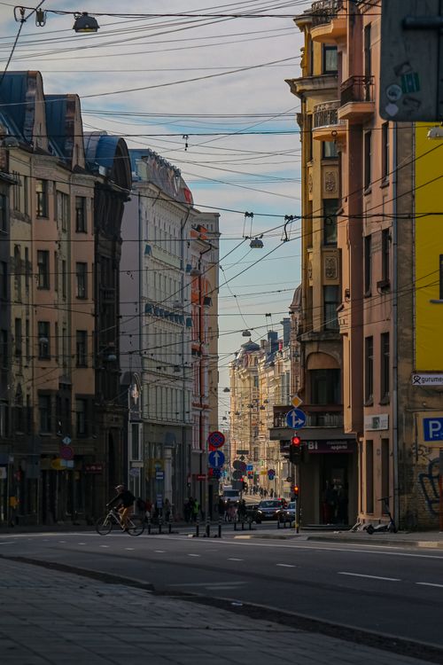 Free Charming street view in Riga showcasing historic buildings and urban life. Stock Photo