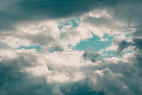 Free A compelling view of dramatic clouds with open blue sky shining through, showcasing the dynamic beauty of nature. Stock Photo