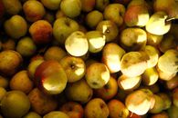 A vibrant collection of fresh golden apples, showcasing their natural texture and colors in sunlight.