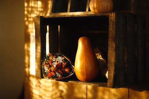 Autumn Still Life of Pumpkin and Bunch of Dried Strawflowers in Wooden Crate