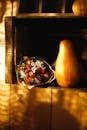 Autumn Still Life of Pumpkin and Bunch of Dried Strawflowers in Wooden Crate