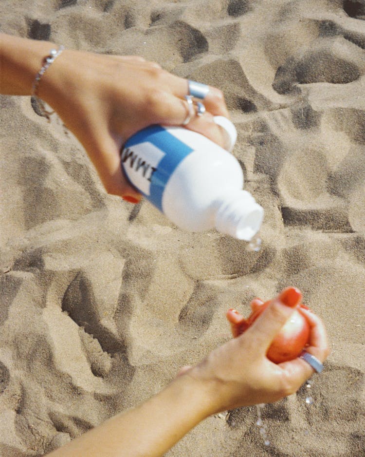 Woman Hands Holding Bottle Of Water And Apple