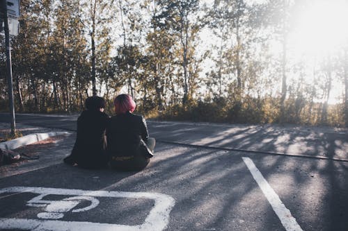 People Sitting on a Parking Lot