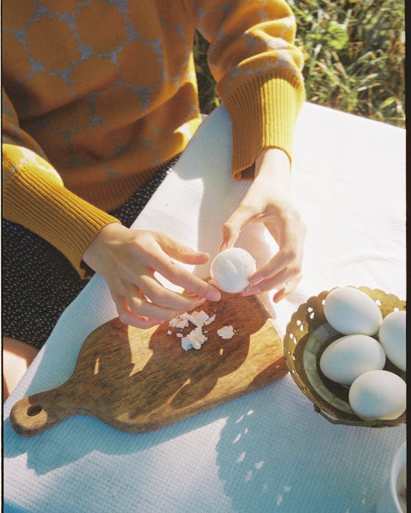Free Person Peeling an Egg Stock Photo