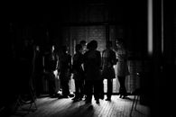 Silhouettes of People Standing on the Wooden Floor