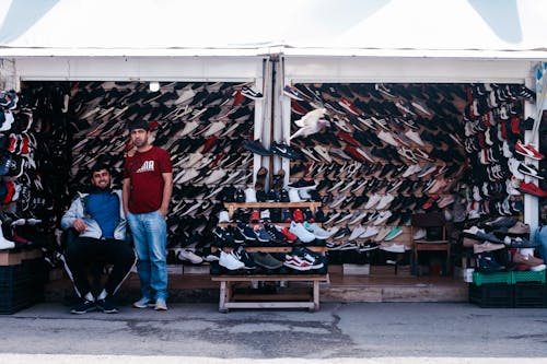 Free Men on a Shoe Stall Stock Photo