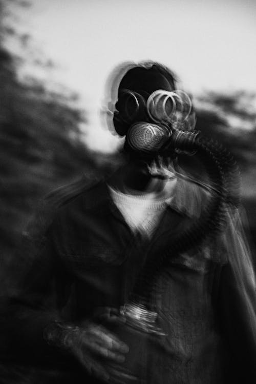 Blurry Photograph of Person in Gas Mask