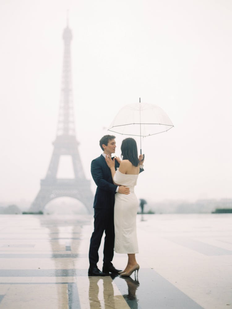 Couple Standing Near The Eiffel Tower 